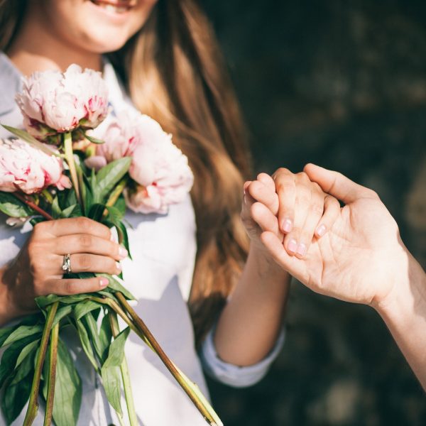 woman-with-engagement-ring-and-peony-bouquet.jpg